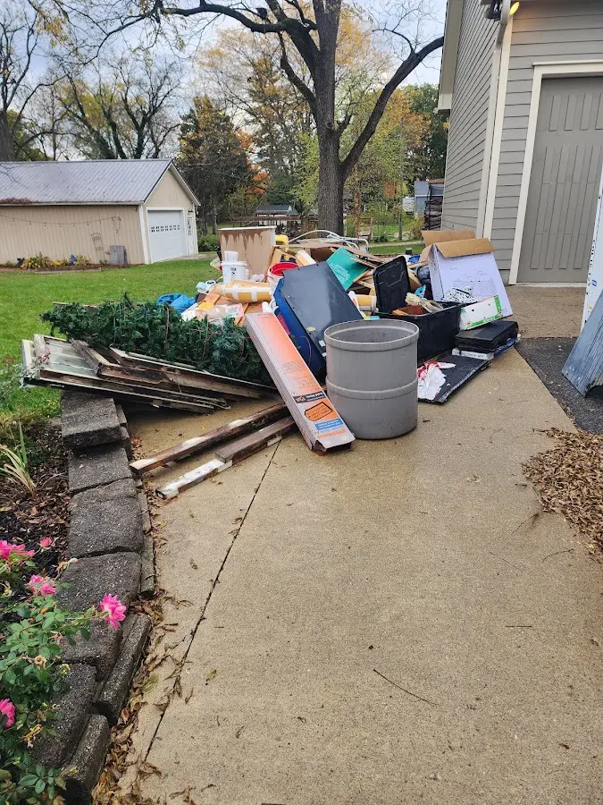 Dumpster being loaded with debris for 12 Yard Dumpster Rental in Glenwood
